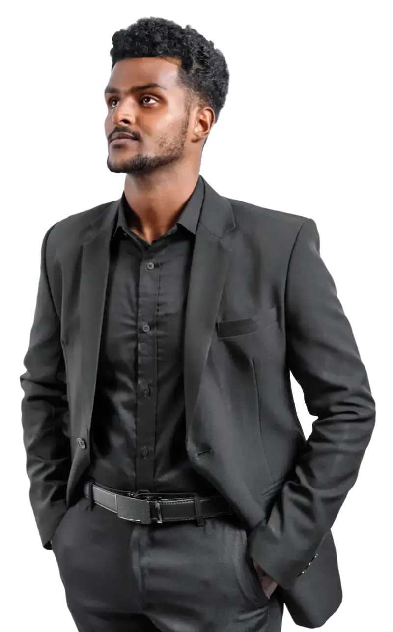 A smartly dressed Indian man in a black suit in deep thought